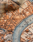 Vintage map of a city layout with streets and waterways, featuring French text.