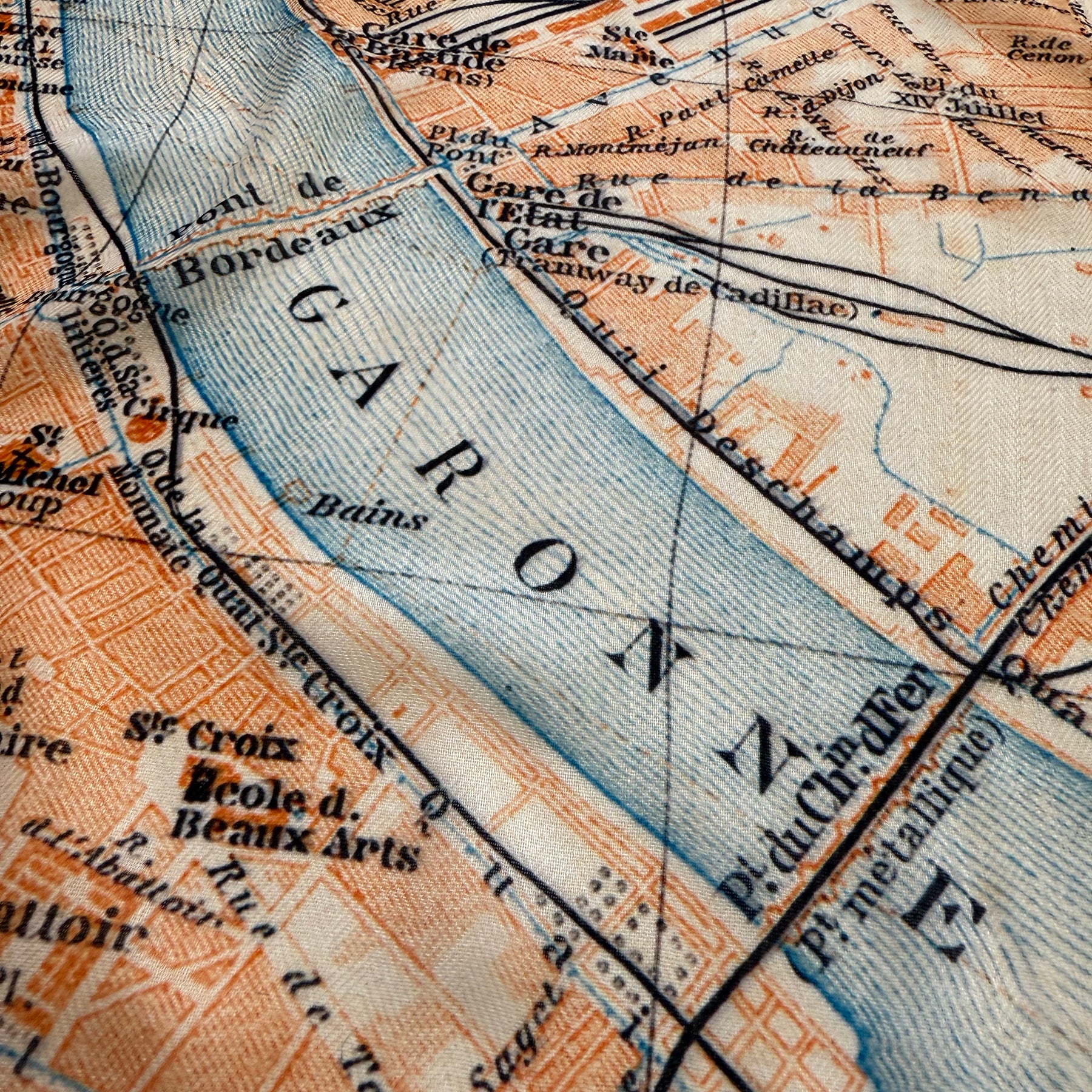 Close-up of an old map with detailed street names and waterways.