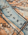 Close-up of an old map with detailed street names and waterways.