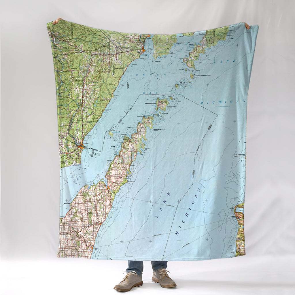Door County, WI map blanket with a person standing underneath on a white background