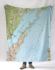 Door County, WI map blanket with a person standing underneath on a white background