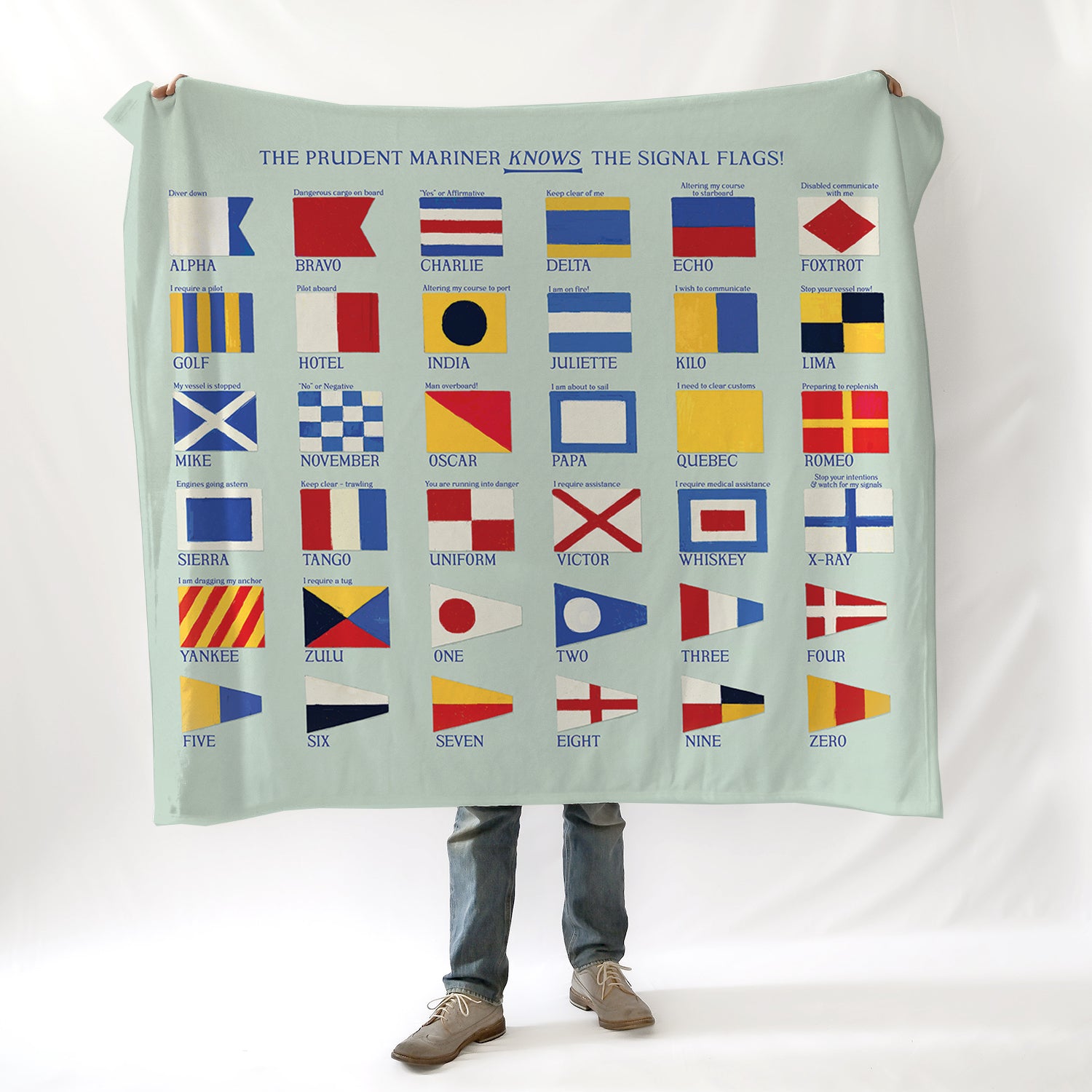 Person holding a blanket with signal flags on a white background