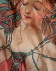 Artistic depiction of a woman's chest with decorative chainmaille design.