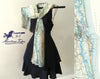 A scarf with a vintage topographic map design, featuring shades of blue and beige, displayed on a mannequin wearing a black dress.